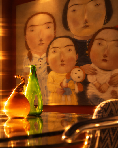 Collectible objects and expressive canvas in an amber gallery